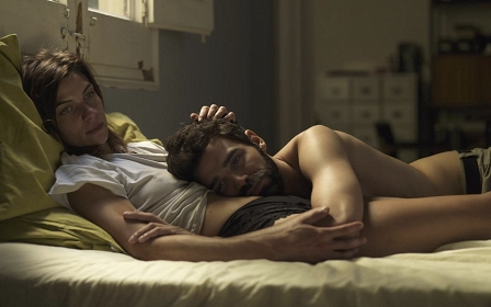 Filmstill aus "Long Distance": Ein Paar liegt im Bett in zärtlicher Pose